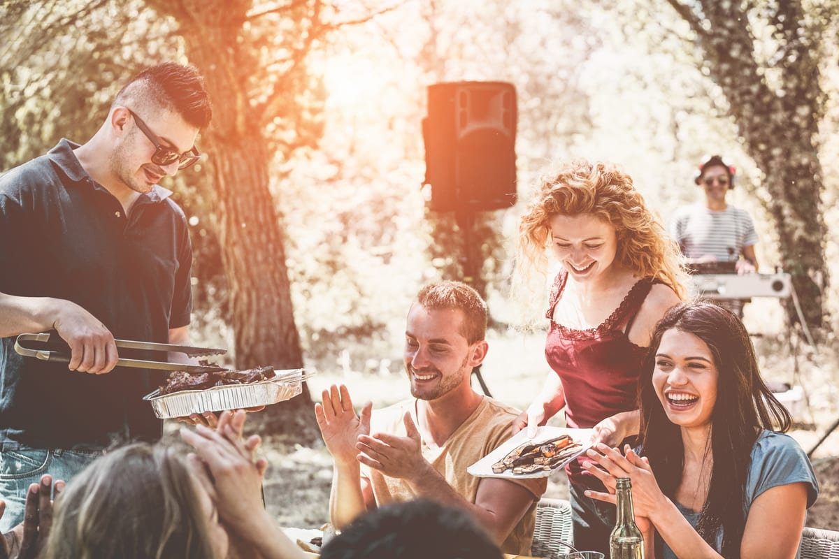 Hire sound system — happy friends eating and drinking at barbecue part for parties and events in Johannesburg, Sandton and Randburg