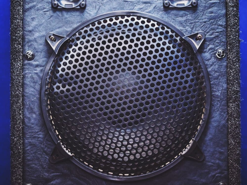 Hire sound system — speaker grille close up on blue textured backgroun for parties and events in Johannesburg, Sandton and Randburg